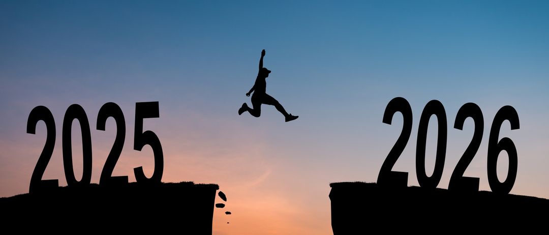 Eine Silhouette einer Person, die vom Felsvorsprung mit der Nummer 25 auf einen anderen Felsvorsprung mit der Nummer 2025 springt.