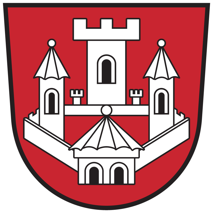 Ein roter Schild mit einer weißen Burg darauf. Die Burg hat drei Türme, der mittlere ist größer, und ein spitzes Dach. Die Türme haben spitze Dächer.