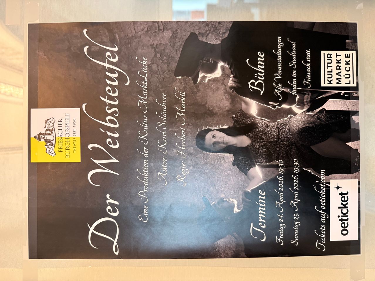 Plakat für 'Der Weibstefel' mit zwei Darstellern in Vintage-Kleidung. Der Text ist auf Deutsch und enthält Termine und Namen, die mit der Produktion in Verbindung stehen.