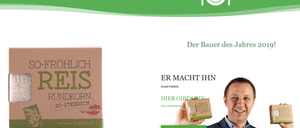 Eine Werbung für Reis, eine Marke für österreichisches Mais, mit einem Bauern, der eine Box Reis-Mais hält. Der Text lautet '100% Steirisch!' mit einem Logo von Teller und Gabel.