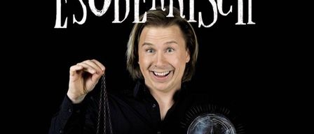 Ein Mann mit lächelndem Gesicht hält eine goldene Taschenuhr in einer Hand und eine Glaskugel in der anderen. Der Text 'ESODERRSCH' steht oben.