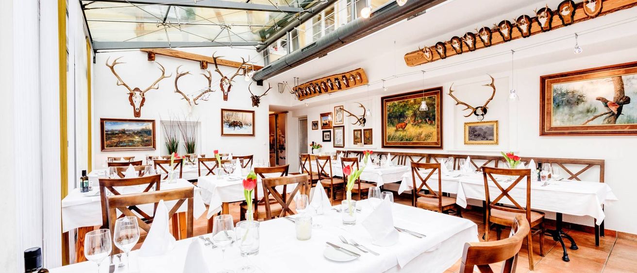 Bild enthält, Indoors, Restaurant, Dining Table, Furniture, Table, Dining Room, Cup, Hall, Antelope, Wildlife