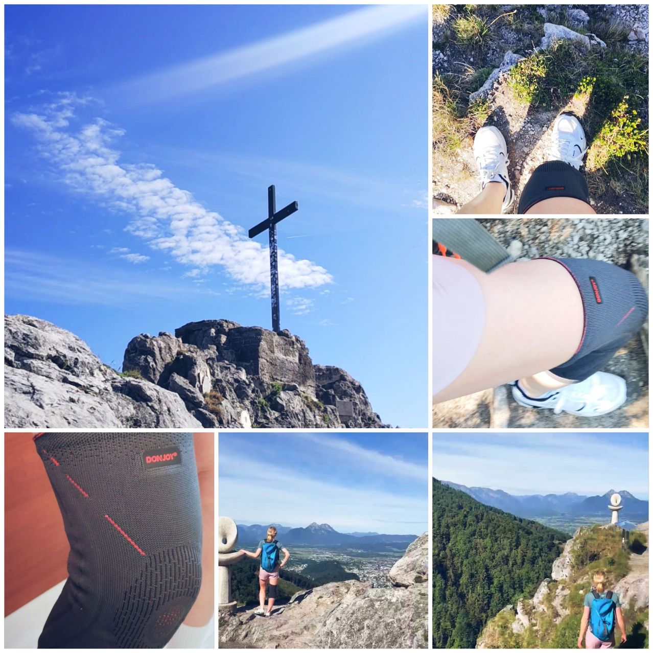 A hiker in mountain gear is atop a rocky peak with a cross in the background. Another hiker in a blue backpack is on a lower cliff.
