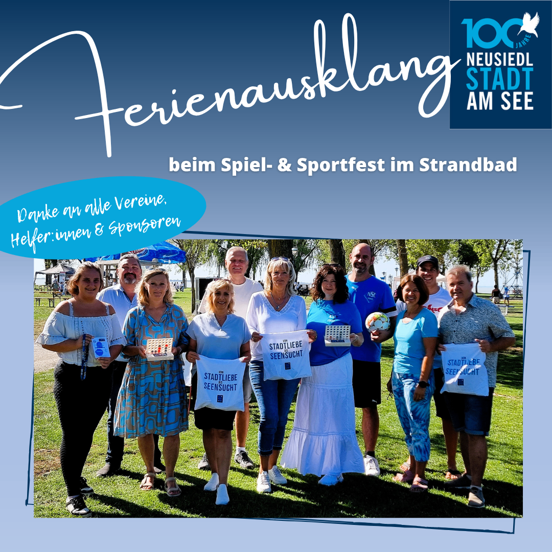 A group of people are standing in a park, holding signs that say Stadtliebe Seesucht. They are smiling and posing for a photo. The background is a grassy field with trees and a blue sky.