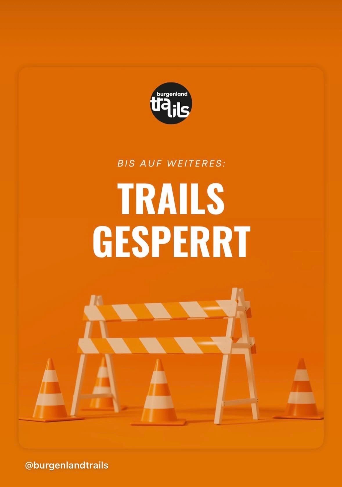 Ein orangefarbenes Poster zeigt den Text 'BIS AUF WEITERES: TRAILS GESPERRT' mit einer weißen Absperrung und Verkehrskegel im Vordergrund. Der Hintergrund ist einfarbig orange.