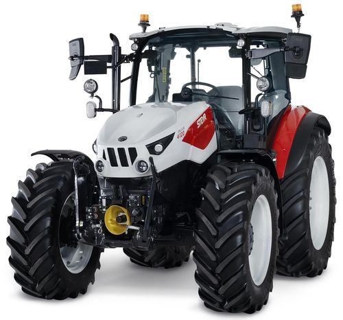 Ein moderner, weißer und roter Traktor mit großen Reifen, einem gelben vorderen Gitter und einem klaren Blick auf den Motor.