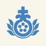 A blue emblem featuring a cross with a circular design, surrounded by six small circles, and flanked by leaves.