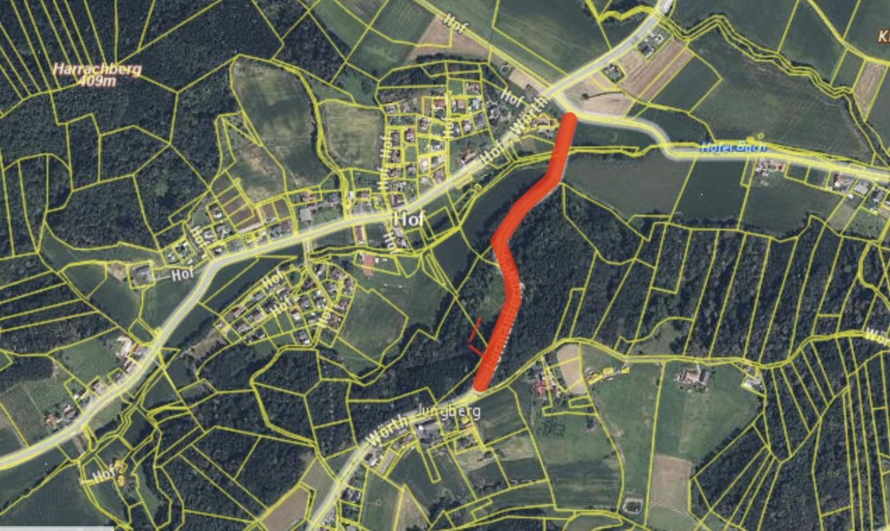 A satellite map shows a rural area with a winding red line indicating a road. The area is surrounded by green fields and small buildings.