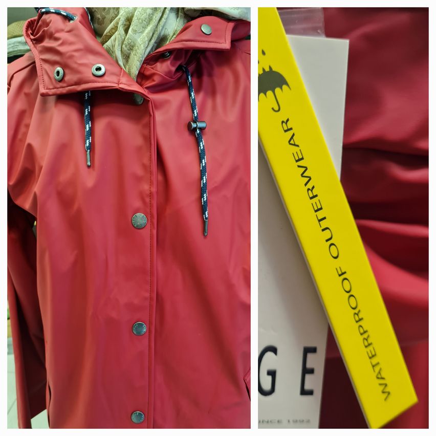 A red raincoat with silver buttons and blue zippers. A yellow tag with black writing is visible, labeled 'WATERPROOF OUTERWEAR.' The brand name 'GE' is also visible.