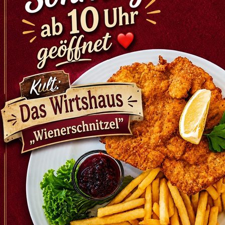 Ein Teller mit gebratenem Hähnchen mit einer Zitronenscheibe und Petersilie, begleitet von Pommes Frites und einer Schüssel mit Cranberry-Sauce. Der Teller liegt auf einem roten Hintergrund mit einem Holzschild, das 'Das Wirtshaus' und ein Herzsymbol zeigt.