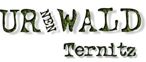Das Bild zeigt einen stilisierten Text 'Ur Neuen Wald Ternitz' mit 'Ur' und 'Wald' in einer Blattschrift und 'Neuen' und 'Ternitz' in einer Standardschrift. Der Text ist grün.
