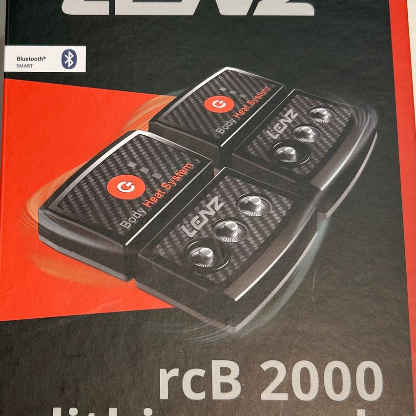 Die Produktbox zeigt einen schwarzen und orangefarbenen Hintergrund mit einem Design von drei LENZ Body Heat System Controllern. Jeder Controller hat ein kreisförmiges Logo und mehrere silberne Knöpfe. Der Produktname und die Modellnummer 'rCB 2000' sind in Weiß angezeigt.