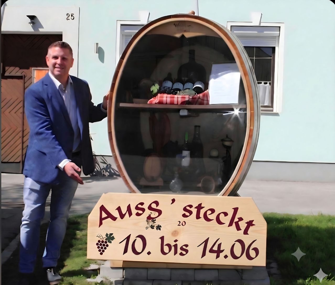 A man stands next to a large wine barrel display, showcasing bottles and a sign indicating it is open from June 10 to June 14.