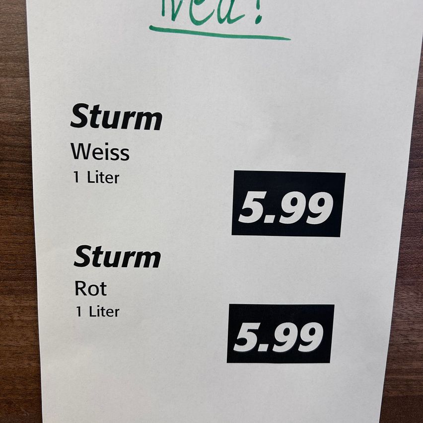 A white sheet of paper displays two drink options: Weiss and Rot, each priced at 5.99. The text is written in black and green.