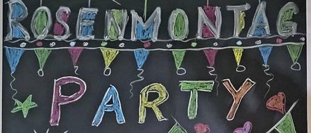 A chalkboard drawing of a smiling man wearing a hat and smoking a cigarette, with colorful party decorations around him. It reads 'Party' at the top.