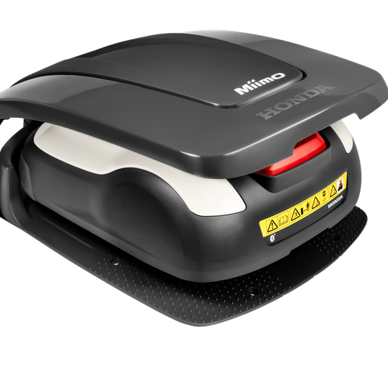 Ein schwarzes und weißes Gerät mit 'MIMO' und 'HONDA' Text, einem roten Knopf und einem gelben Aufkleber mit Warnsymbolen auf schwarzem Hintergrund.