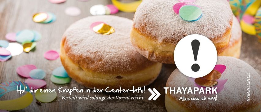 Zwei pulverisierte Donuts mit farbigem Konfetti oben, umgeben von anderem buntem Papier. Ein Schild zeigt 'THAYAPARK' und 'Alles was ich mag!'. Darunter steht 'Verteilt wird solange der Vorrat reicht'.
