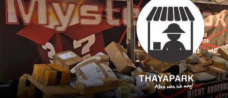 A pile of boxes with a logo for Mystes7 and a silhouette of a person in a hat.