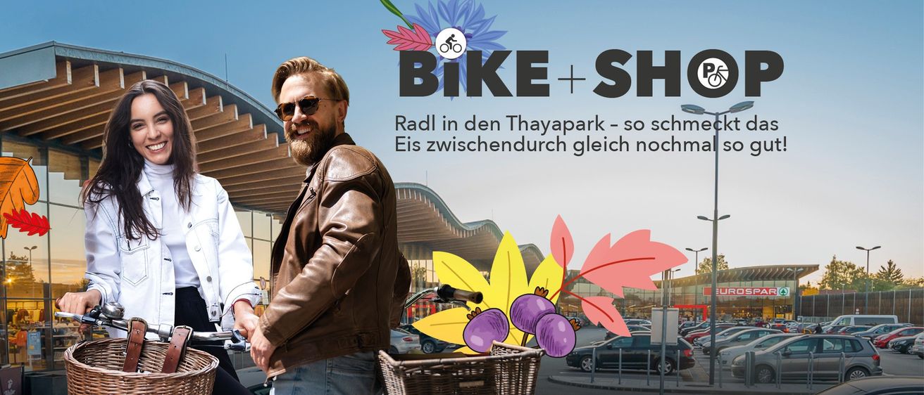 A man in a brown leather jacket and sunglasses stands next to a bicycle with a basket in front of a modern building. The text reads 'Bike + Sh' and 'Radl in den Thaypark - so so Eis zwischendurch gleich noo'.