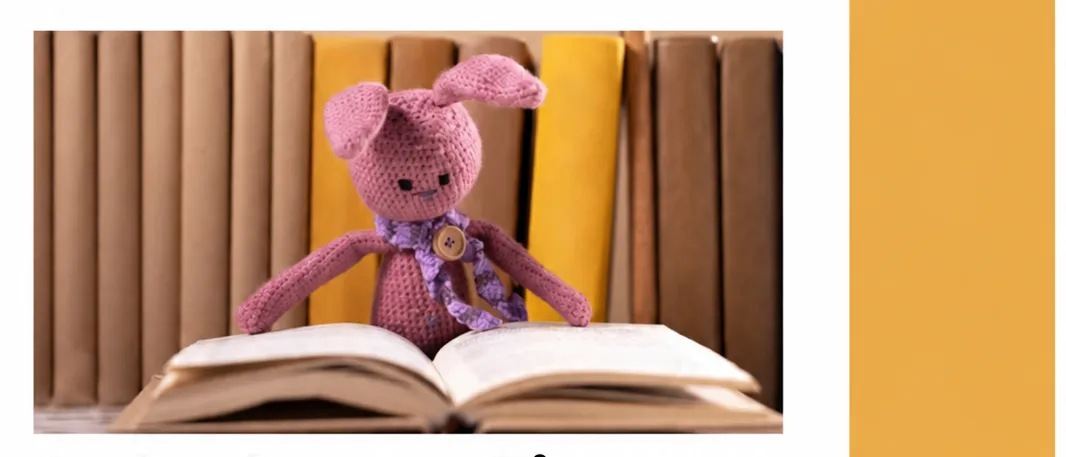 A poster for an event called Bücher Zwerge, featuring a pink crocheted rabbit sitting on an open book. The poster includes details about the event, such as the date and time, and a location address.