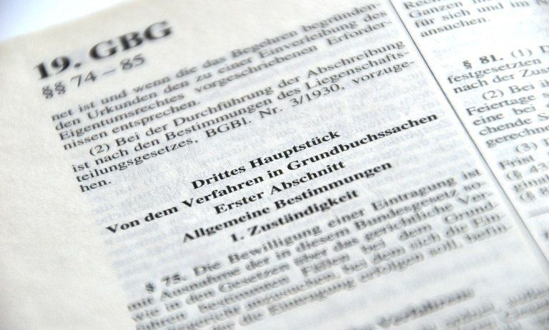 Nahaufnahme einer Seite mit rechtlichen Texten. Oben steht '19. GBG'. Abschnitte beinhalten 'Drittes in Genehmigung' und 'Allgemeine Bestimmung'. Die Seite hat auch numerische Verweise und Abschnitte mit Text in kleinerer Schrift.