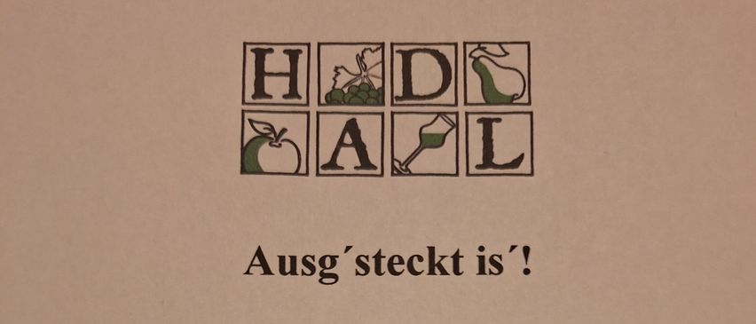 Das Bild zeigt eine Werbung für ein Wein- und Apfelmost-Festival. Der Text lautet 'Ausg'steckt ist!' und gibt die Daten vom 28. Jänner bis 1. Februar 2026 an. Es enthält Kontaktdaten für die Familie HADL in Gerasdorf.