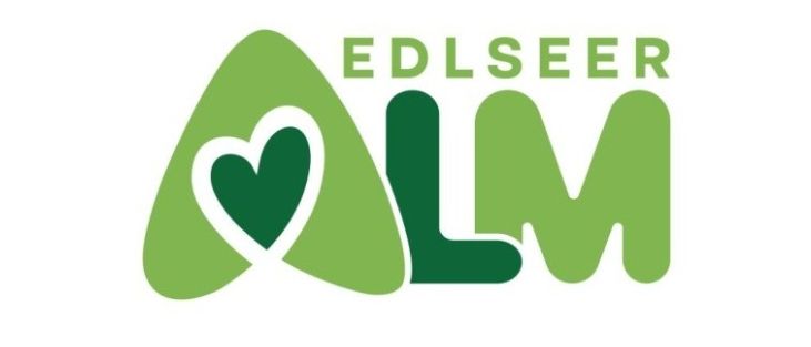 Das Logo von Edlseeer LM zeigt ein grünes Herzsymbol innerhalb eines grünen Dreiecks, mit den Buchstaben LM in Grün darunter und dem Wort Edlseeer in grünen Großbuchstaben darüber.