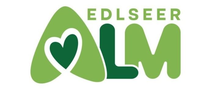 Das Logo für Edlseer AL M zeigt ein grünes Herz, das in die Buchstaben AL M integriert ist. Die Farbe Grün ist im gesamten Design vorherrschend.