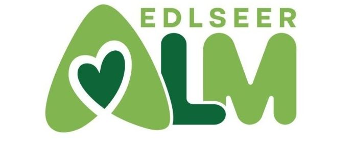 Edlseer LM Logo mit einem Herzsymbol, das in den Buchstaben A integriert ist. Das Logo ist überwiegend grün.