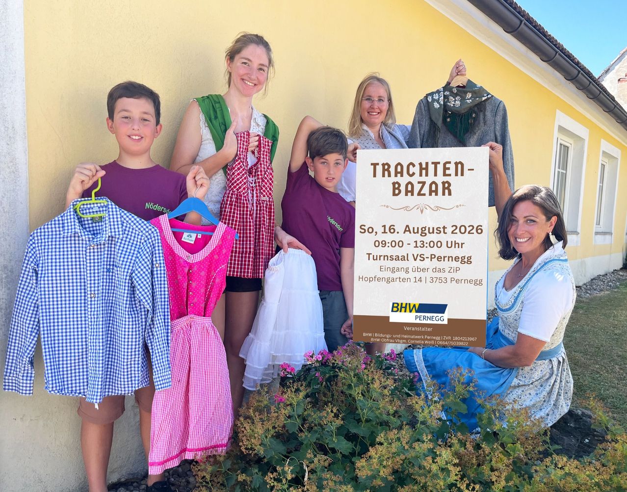 A group of people are standing next to a sign that says 'Trachten-Bazar'. They are holding up clothing items and smiling. The sign indicates a traditional clothing bazaar event on August 16, 2026.