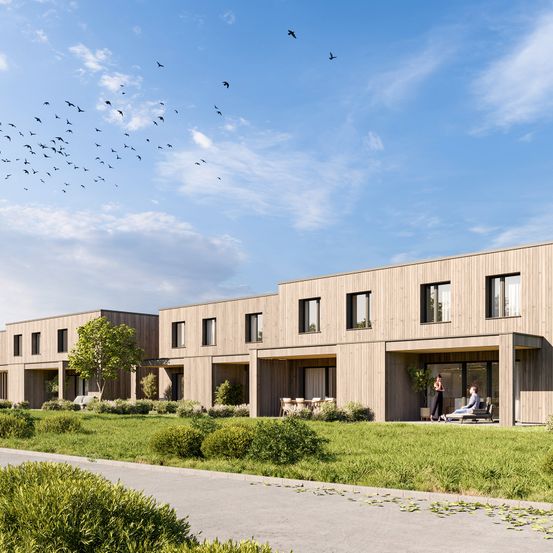 Eine künstlerische Darstellung eines modernen Wohnkomplexes mit großen Fenstern und einem grünen Rasen.