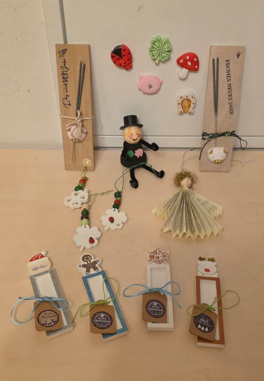 A collection of handmade Christmas bookmarks and ornaments, including a Santa Claus bookmark, a gingerbread man bookmark, and various decorative items like a pig, a mushroom, and a ladybug.