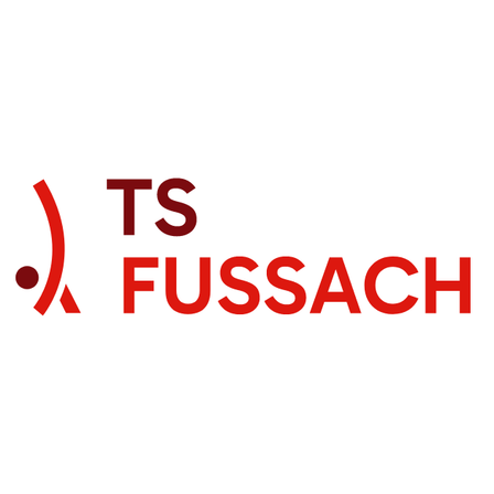 Das Logo von TS Fussach zeigt einen stilisierten Buchstaben 'A' mit einem Punkt im Inneren und den Buchstaben 'TS' darüber, alles in Rot.