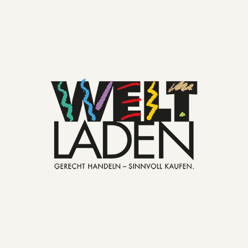 Das Logo für Welt Laden zeigt ein farbenfrohes und dynamisches Design mit dem prominenten Schriftzug Welt Laden. Darunter steht 'Gerecht Handeln - Sinnvoll Kaufen,' was auf fairen und sinnvollen Einkauf hinweist.