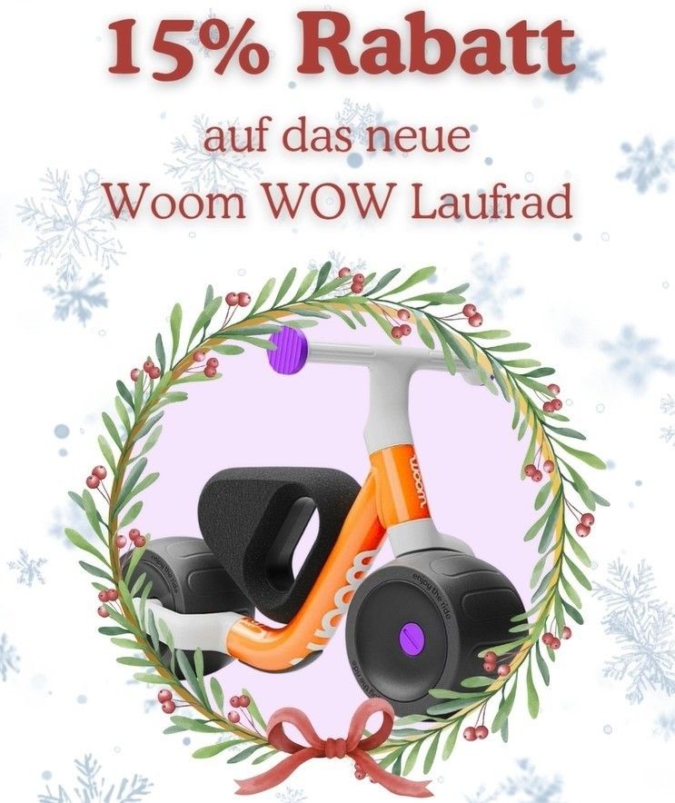Eine Werbung zeigt ein neues Woom WOW Fahrrad, umgeben von einem Kranz aus grünen Blättern und roten Beeren, vor einem weißen Hintergrund mit Schneeflocken. Der Text bietet 15% Rabatt.