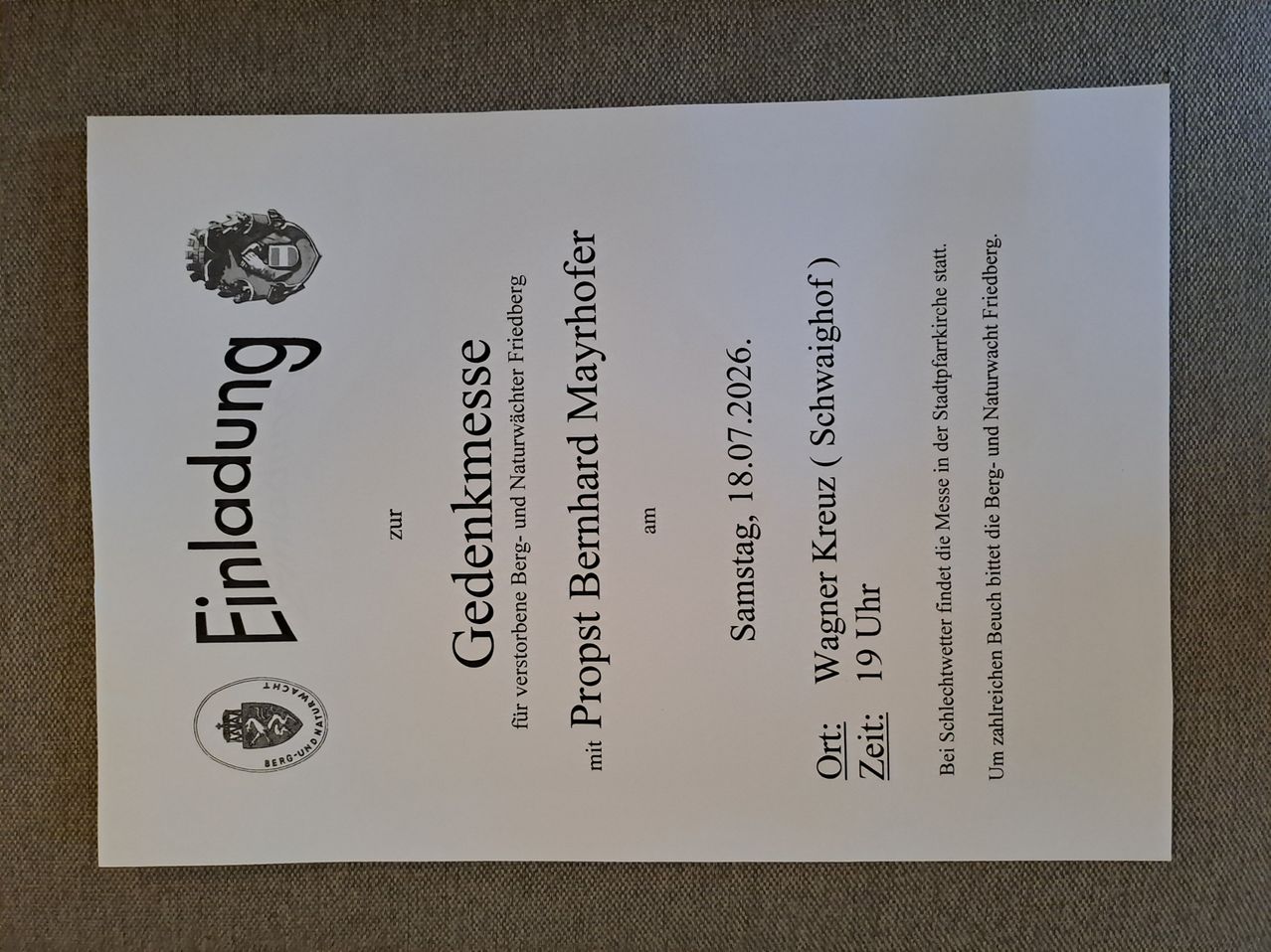 A memorial service announcement for Bernhard Mayrhofer, held on July 8, 2026, at 7 PM at Wagner Kreuz (Schwaighof). The service is in the Stadtpfarrkirche and Naturwach.