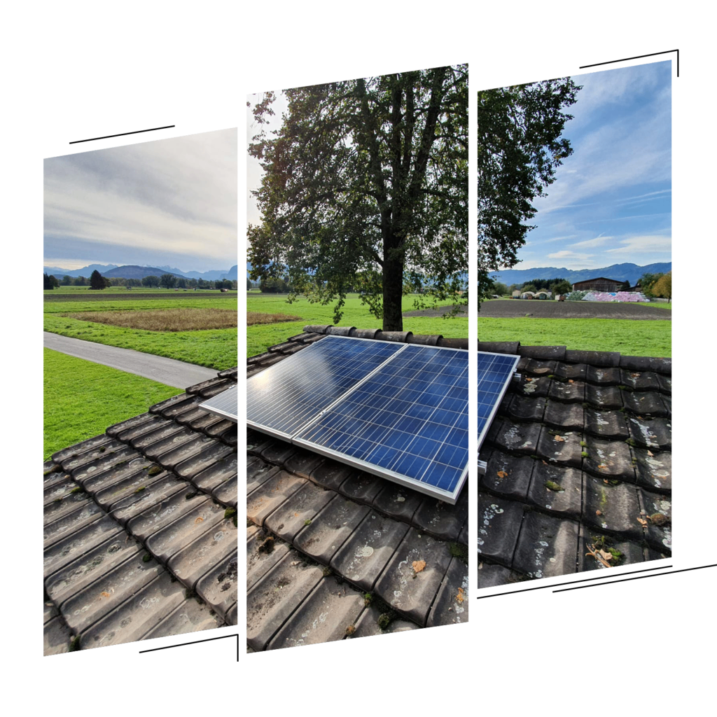 Eine Solarpanel-Anlage ist auf einem Dach installiert, umgeben von einem grünen Feld und einem Baum. Die Landschaft zeigt eine kurvenreiche Straße und entfernte Berge.