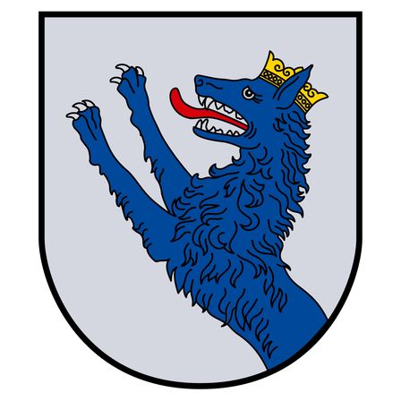 Ein stilisierter blauer Wolf mit einer goldenen Krone ist auf einem Schild abgebildet. Der Wolf hat den Mund offen und streckt eine Pfote nach oben.
