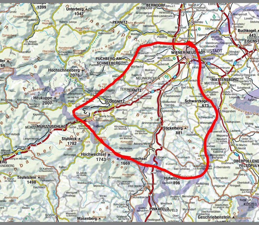 Eine Karte mit verschiedenen Orten und Höhenangaben. Ein roter Kreis hebt einen bestimmten Bereich hervor, möglicherweise als Fokus oder Merkmal. Namen von Bergen und Orten sind markiert.