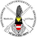 Wappen des Burgerkorps Waidhofen, mit traditionellem österreichischem Hut, Nationalflagge, gekreuzten Gewehre, sowie den Namen Waidhofen und Thaya.