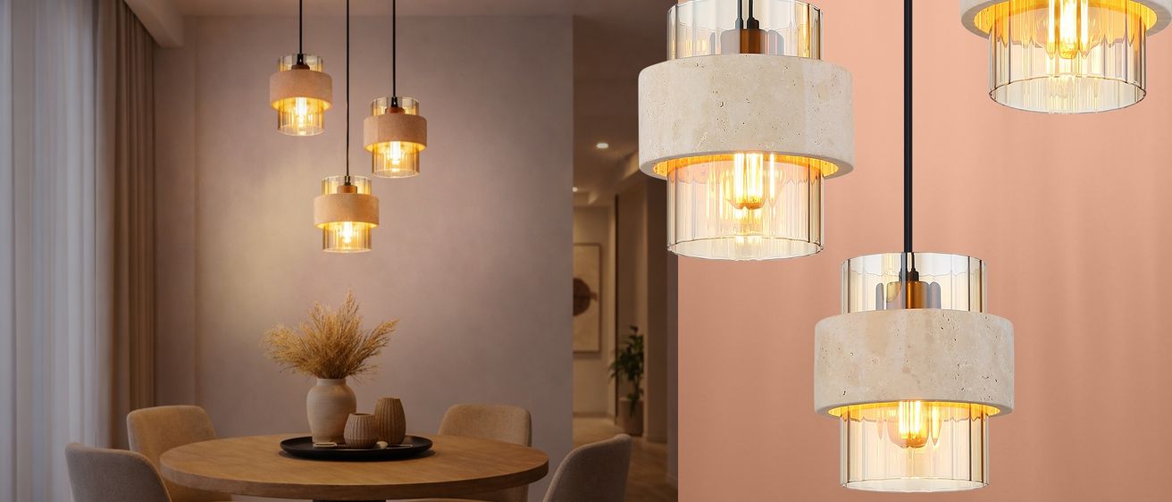 Ein Esszimmer mit einem runden Holztisch und Stühlen. Drei runde Pendelleuchten hängen von der Decke. Auf dem Tisch stehen eine kleine Vase und ein Teller. Im Hintergrund führt eine Tür in einen anderen Raum mit einer Pflanze.