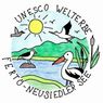 Illustration von Vögeln und einer Sonne über einem See mit Bergen. Der Text lautet UNESCO Welterbe Ferto-Neusiedler See.