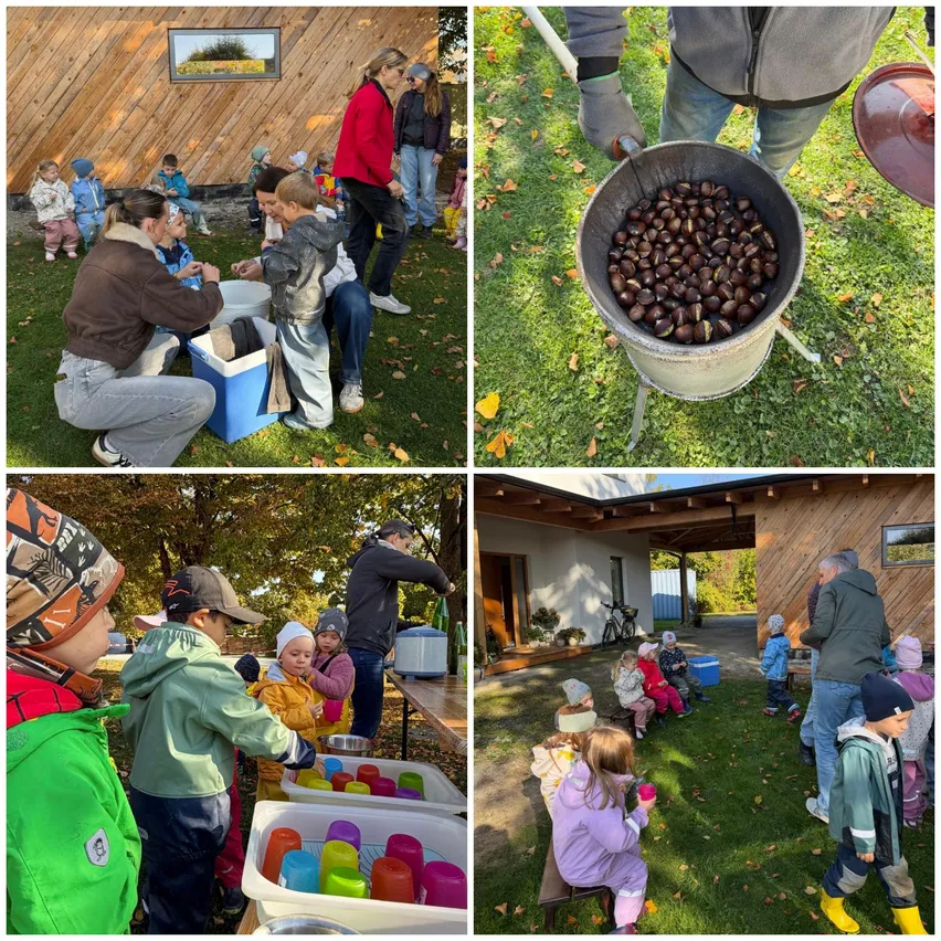 Eine Gruppe von Kindern und Erwachsenen versammelt sich um einen Tisch voller bunter Becher und einer Kühlbox. Einige sitzen auf dem Gras, während andere stehen.