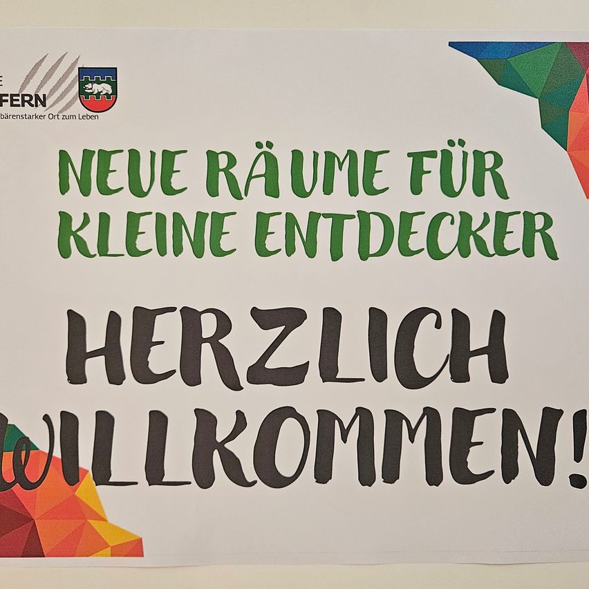 A poster with a colorful geometric design at the top and bottom, featuring a logo and text in German. The text reads 'New rooms for little explorers' and 'Welcome!' in bold, handwritten font.