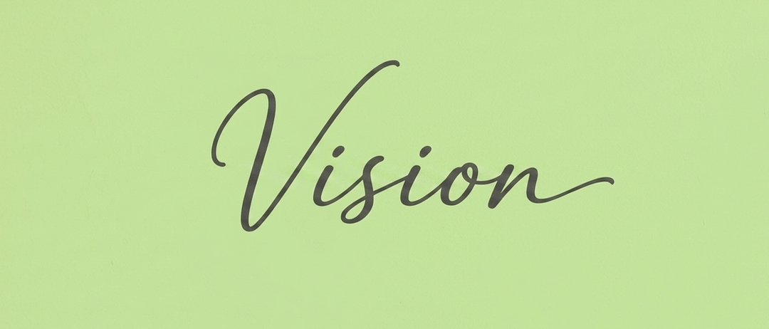 Das Wort 'Vision' ist in kursiver schwarzer Schrift auf einem grünen Hintergrund geschrieben. Die Buchstaben sind groß und über das Bild verteilt.