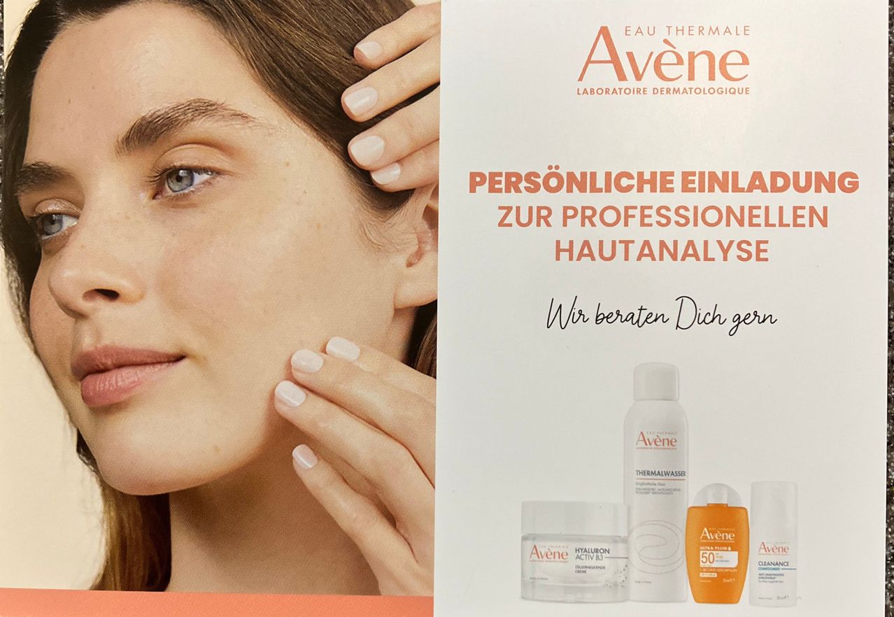 An advertisement for Avène skincare products with a woman touching her face and bottles in the background.
