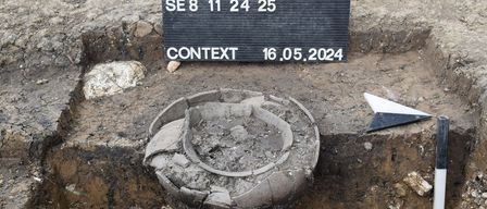 Ein archäologischer Ausgrabungsort mit einer Markierung MNR.56209.24.03 KG Hallein Schnitt 5 Profil 8 SE 8 11 24 25 Kontext 16.05.2024. Daneben sind ein Pfeil und ein Lineal für Maßstab platziert.