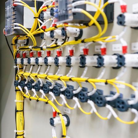 Ein Schaltkasten mit mehreren Drähten und Anschlüssen in verschiedenen Farben, die daran befestigt sind.