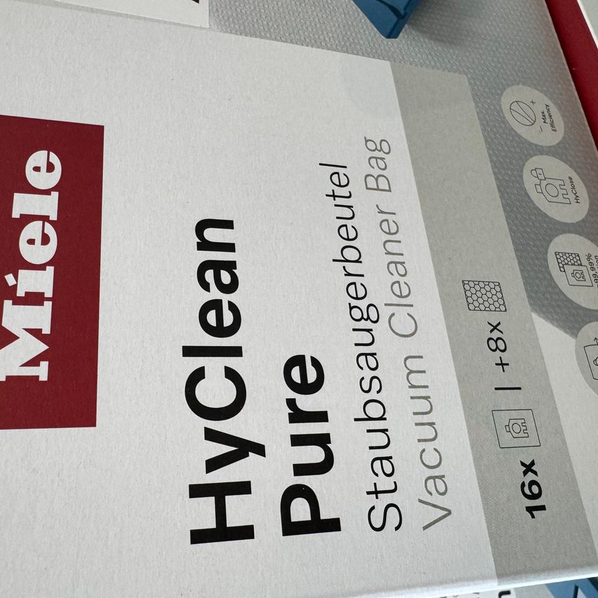 Close-up of a box of Miele HyClean Pure vacuum cleaner bags. It includes 16 bags, suitable for vacuum cleaners with an 8-liter capacity.