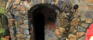Image contains, Arch, Path, Walkway, Fireplace, Crypt, Road, Flagstone, Shelter, Wall, Dungeon
